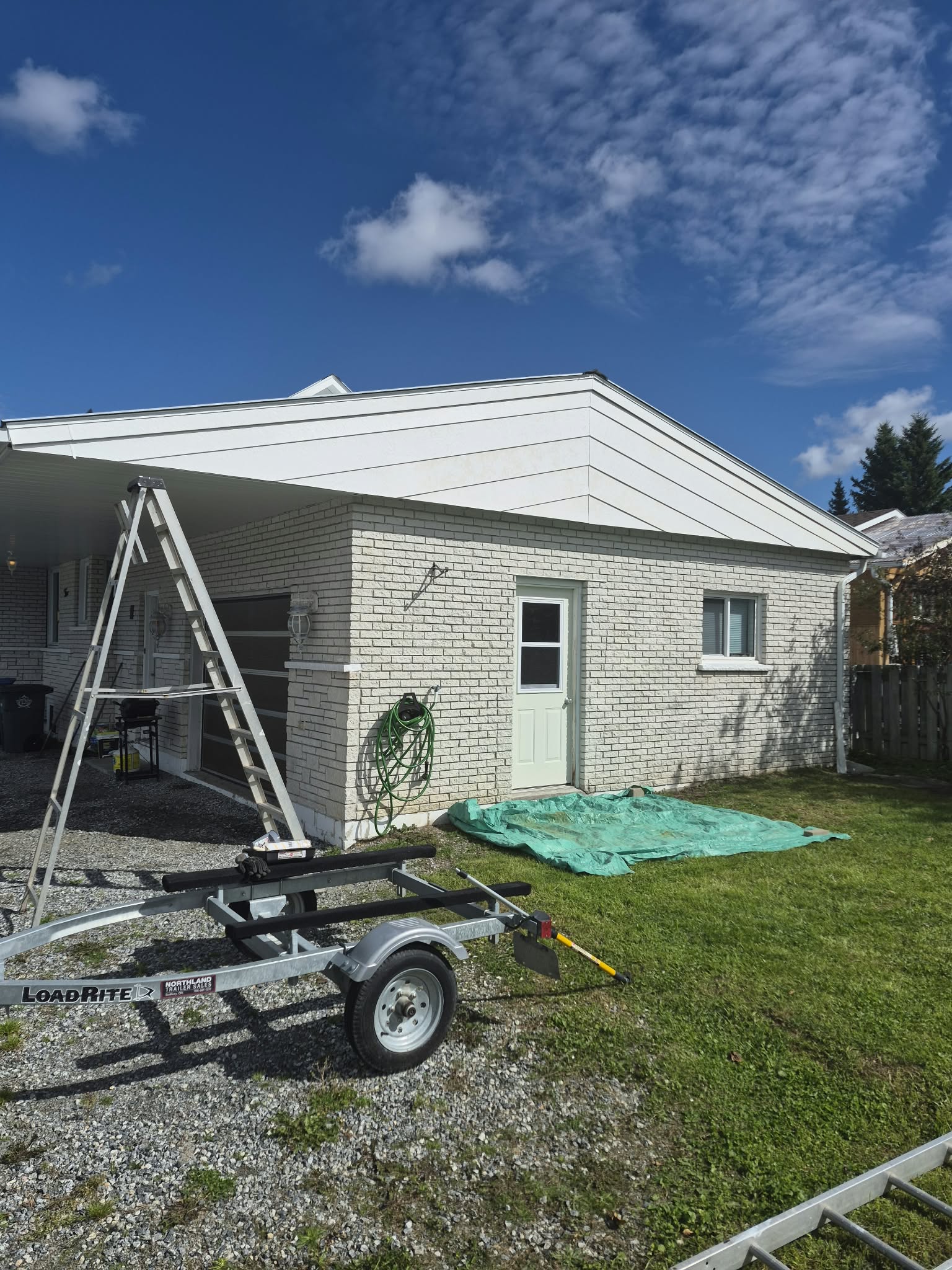 House with new roof and white brick exterior